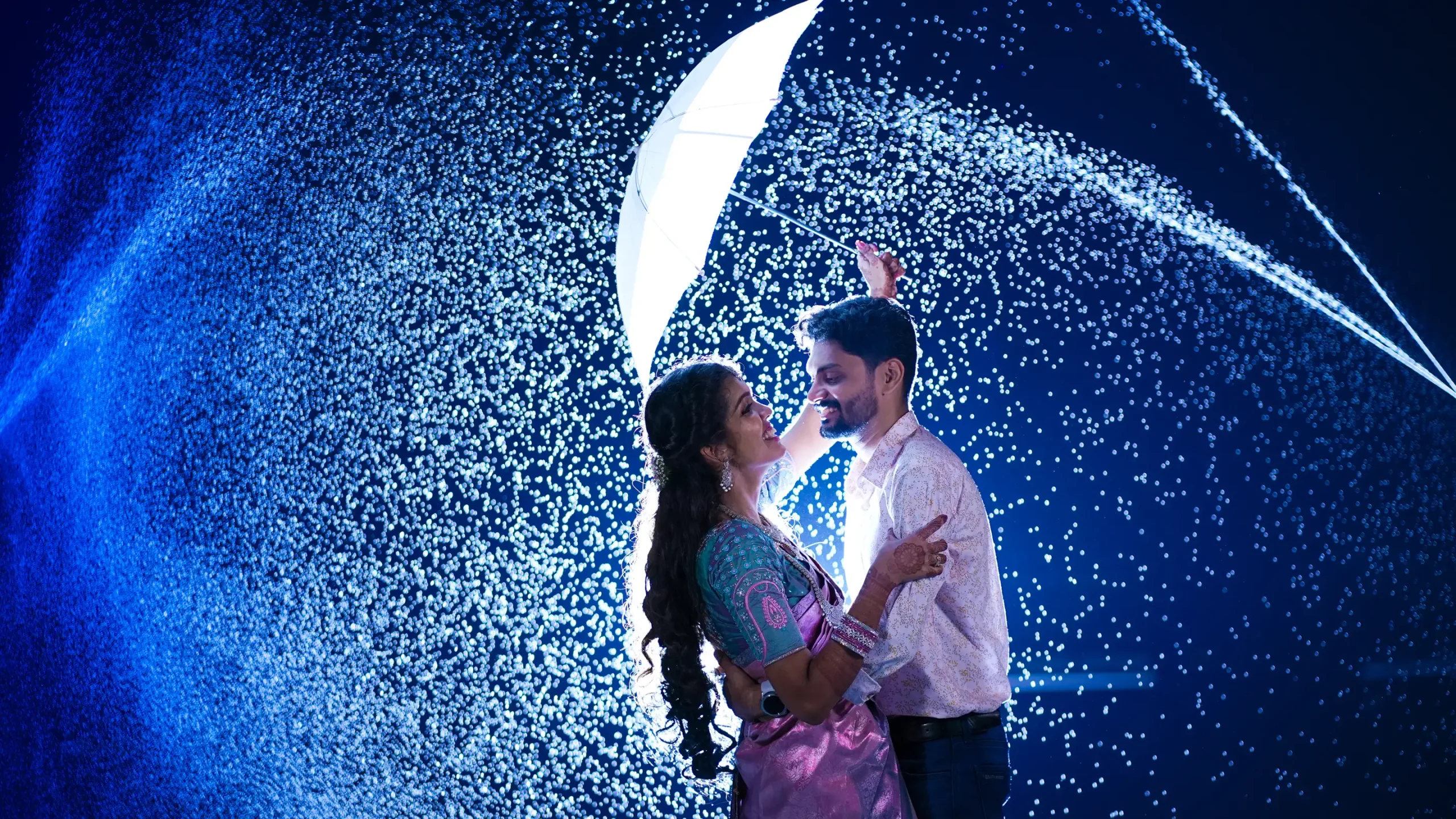 Couple dancing outdoors with a vibrant blue light background.🏢 Yuvi Studio Fotography & Film Making 📷 Best Outdoor Wedding PhotoShoot 📍 Velayuthampalayam, Karur